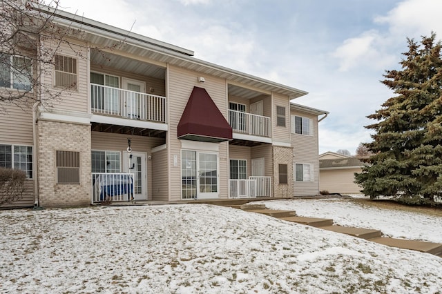 view of snow covered rear of property