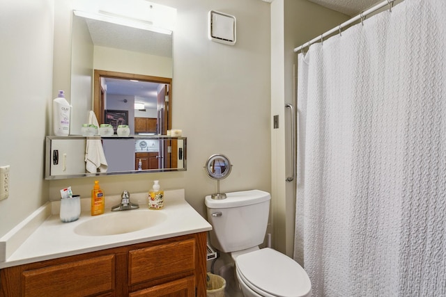 bathroom with vanity, a textured ceiling, and toilet