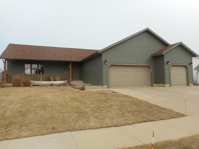 ranch-style house featuring a front lawn, a garage, and a porch