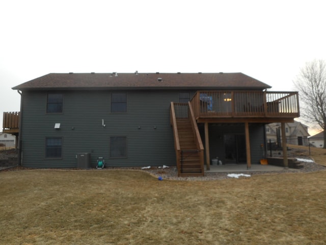 rear view of property with central AC unit, a yard, a patio, and a wooden deck