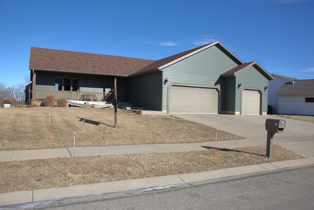 ranch-style house with a garage and covered porch