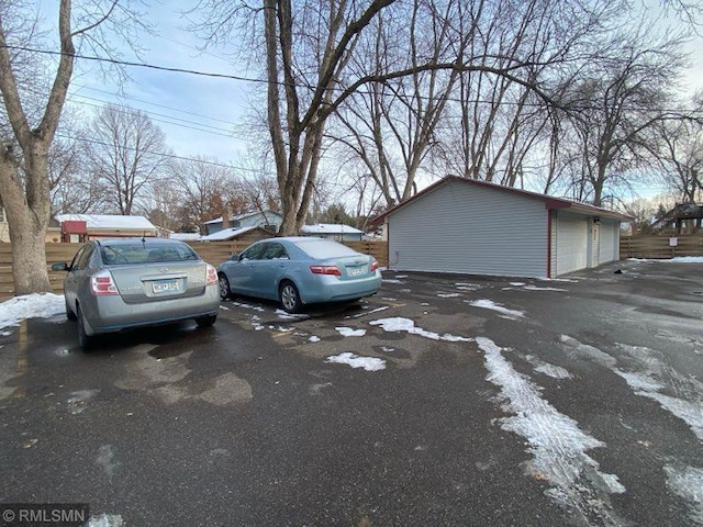 view of vehicle parking featuring a garage