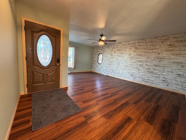 entrance foyer featuring ceiling fan, dark hardwood / wood-style floors, and a textured ceiling