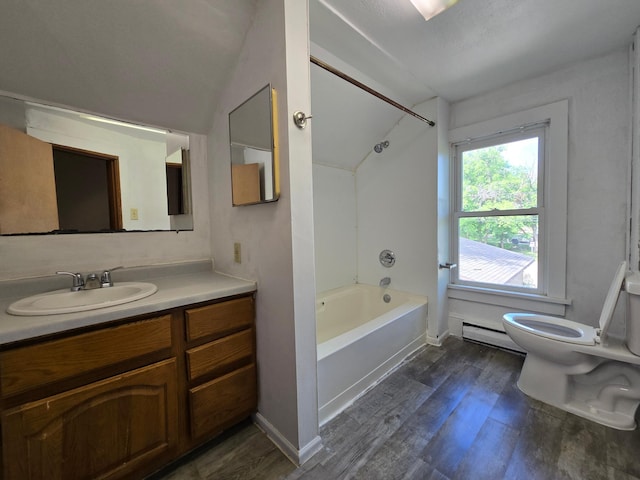 full bathroom with bathtub / shower combination, hardwood / wood-style floors, toilet, a baseboard heating unit, and vanity