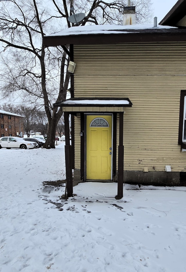 view of snow covered property entrance