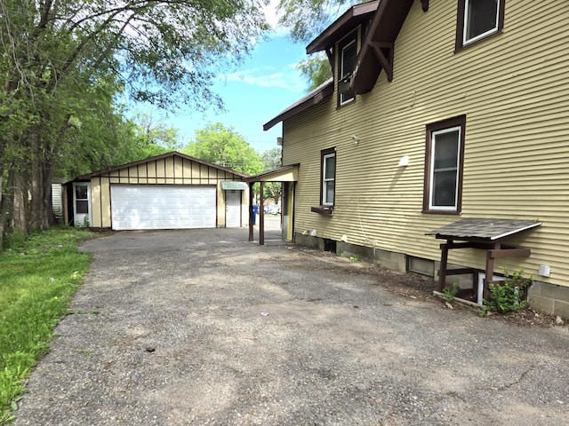 view of side of home with a garage and an outdoor structure