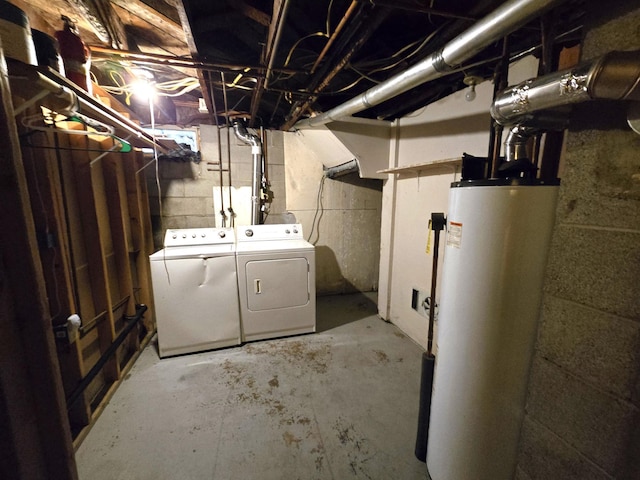 basement featuring water heater and washing machine and dryer