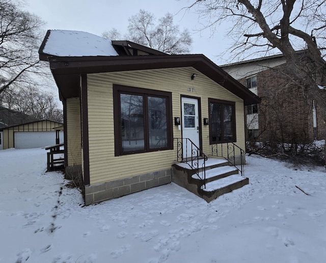 view of front of property with a garage and an outdoor structure