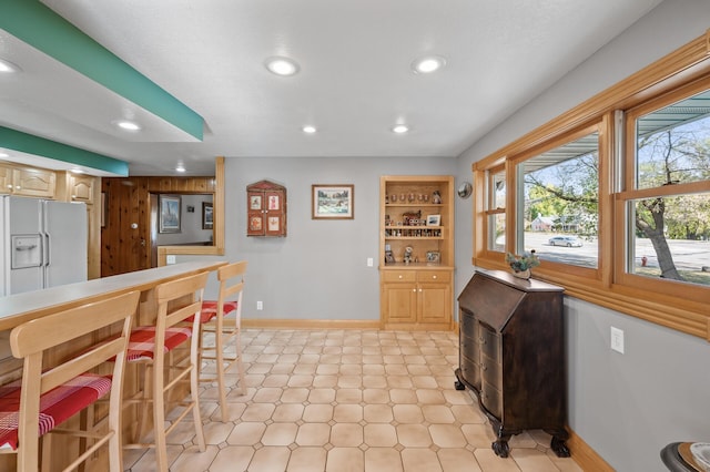 dining area featuring recessed lighting and baseboards