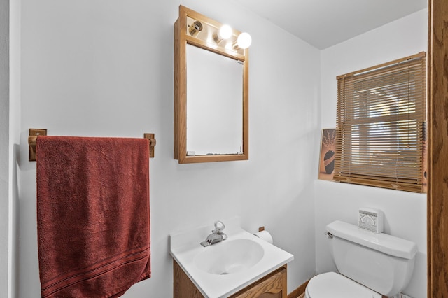 bathroom featuring toilet and vanity