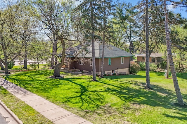view of side of home with a lawn