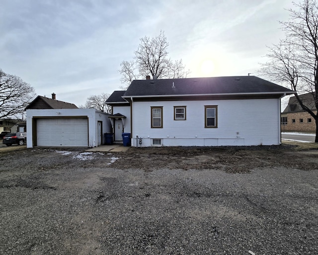 rear view of property featuring a garage