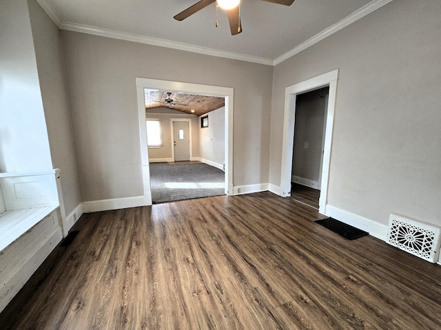 spare room featuring ceiling fan, dark hardwood / wood-style floors, and crown molding