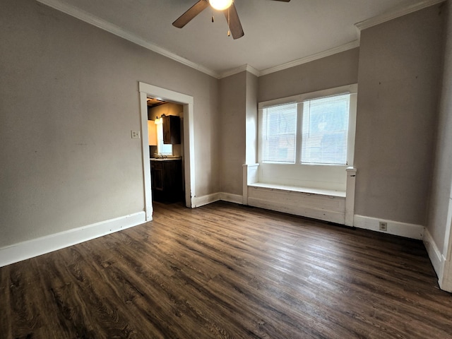 spare room with ceiling fan, dark wood-type flooring, and ornamental molding