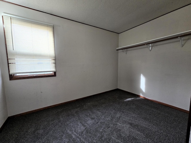 carpeted spare room featuring a textured ceiling