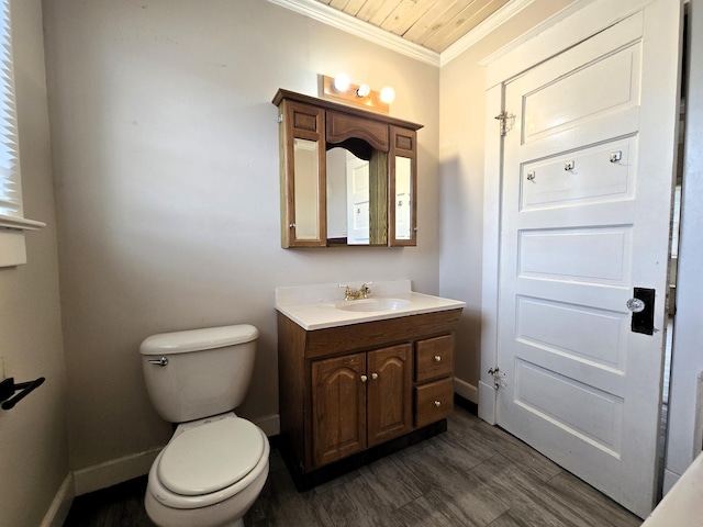 bathroom with toilet, ornamental molding, wood-type flooring, and vanity