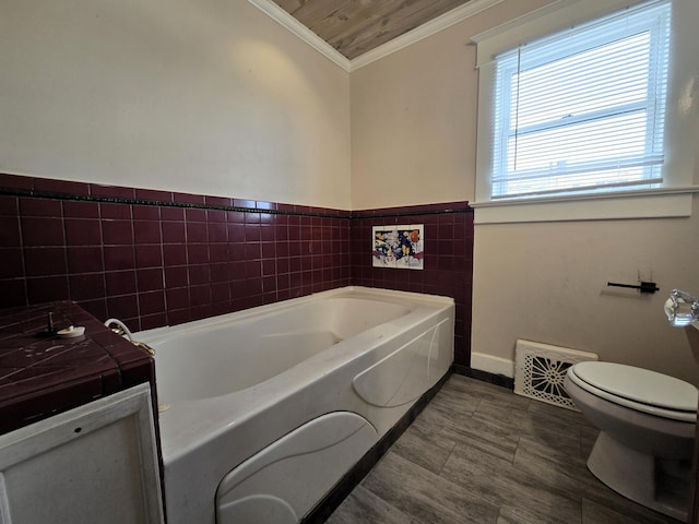 bathroom with toilet, wooden ceiling, tile walls, a tub, and crown molding