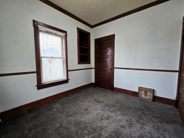 carpeted spare room featuring a textured ceiling and ornamental molding