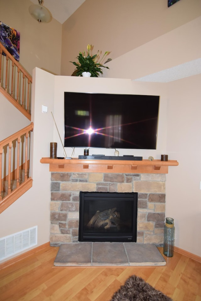 interior details with a fireplace and wood-type flooring