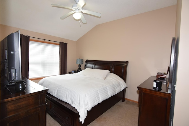 bedroom with vaulted ceiling, light colored carpet, and ceiling fan