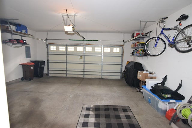 garage with a garage door opener and electric panel