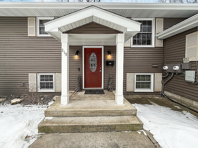 view of snow covered property entrance