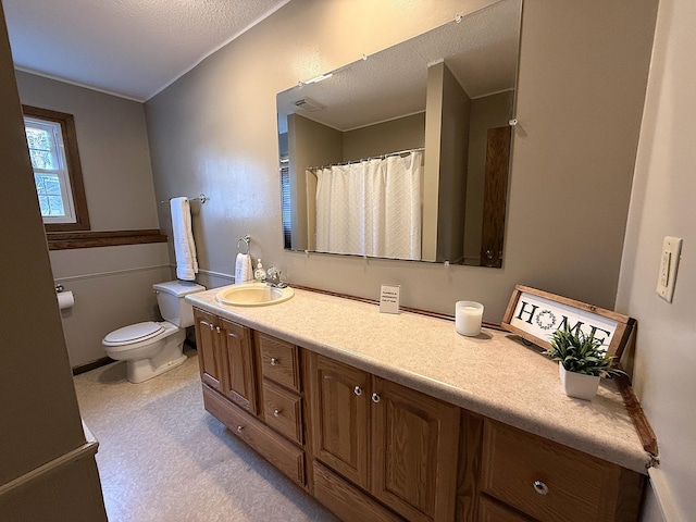 619 10th St, Montevideo, MN 56265 - bathroom with vanity, toilet, and a textured ceiling