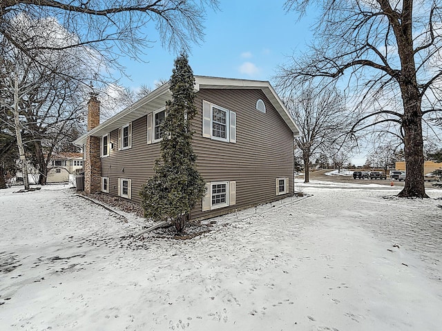 619 10th St, Montevideo, MN 56265 - view of snow covered exterior with a chimney