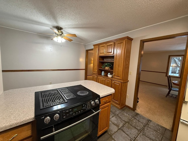 619 10th St, Montevideo, MN 56265 - kitchen with black electric range, light countertops, brown cabinets, a ceiling fan, and a textured ceiling