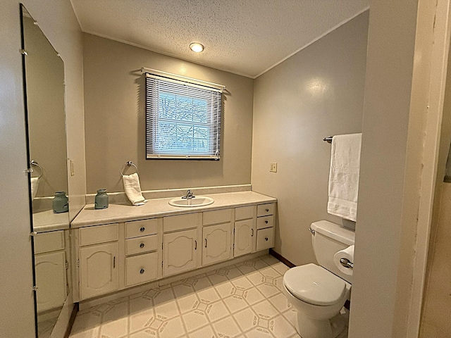 619 10th St, Montevideo, MN 56265 - bathroom with vanity, toilet, and a textured ceiling