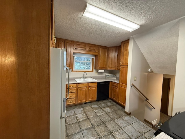 619 10th St, Montevideo, MN 56265 - kitchen with freestanding refrigerator, black dishwasher, a textured ceiling, a sink, and light countertops