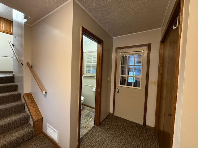 619 10th St, Montevideo, MN 56265 - hall with a textured ceiling, carpet flooring, and stairway
