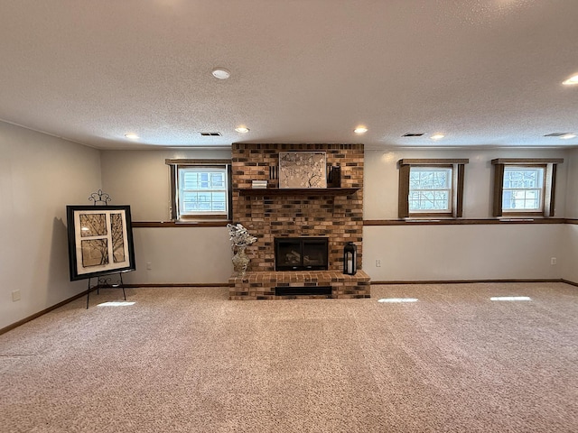 619 10th St, Montevideo, MN 56265 - unfurnished living room with a textured ceiling, healthy amount of natural light, carpet flooring, a fireplace, and recessed lighting
