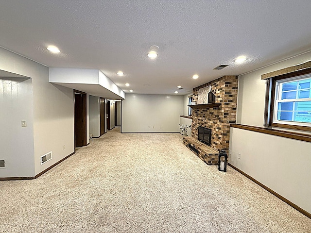 619 10th St, Montevideo, MN 56265 - below grade area with light carpet, baseboards, a brick fireplace, recessed lighting, and a textured ceiling
