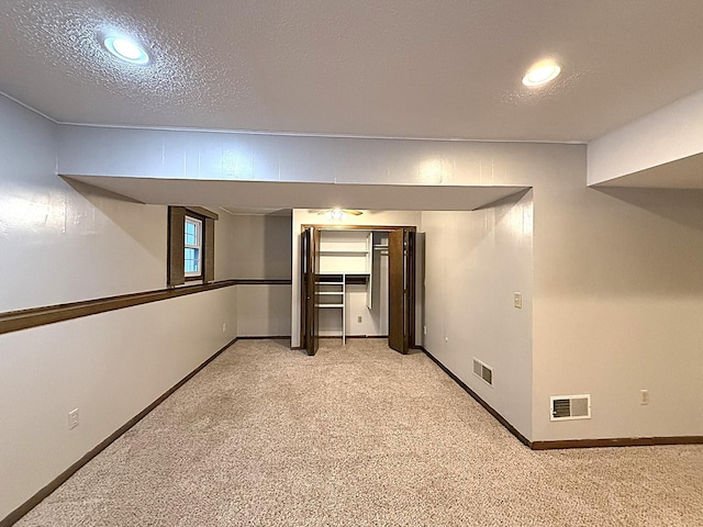619 10th St, Montevideo, MN 56265 - basement with light carpet, recessed lighting, baseboards, and a textured ceiling