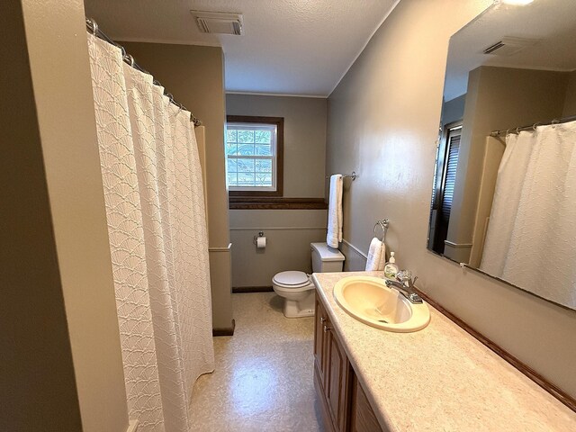 619 10th St, Montevideo, MN 56265 - bathroom featuring vanity, toilet, tile patterned floors, and a shower with shower curtain