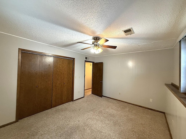 619 10th St, Montevideo, MN 56265 - unfurnished bedroom featuring light carpet, a closet, baseboards, a ceiling fan, and a textured ceiling