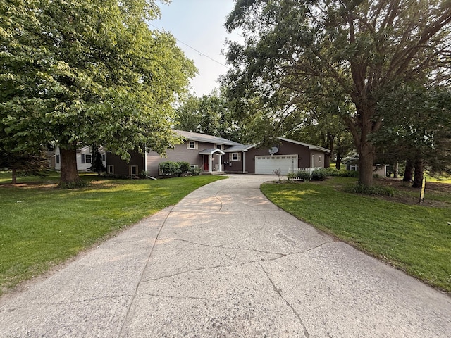 619 10th St, Montevideo, MN 56265 - split level home featuring concrete driveway, a front yard, and a garage