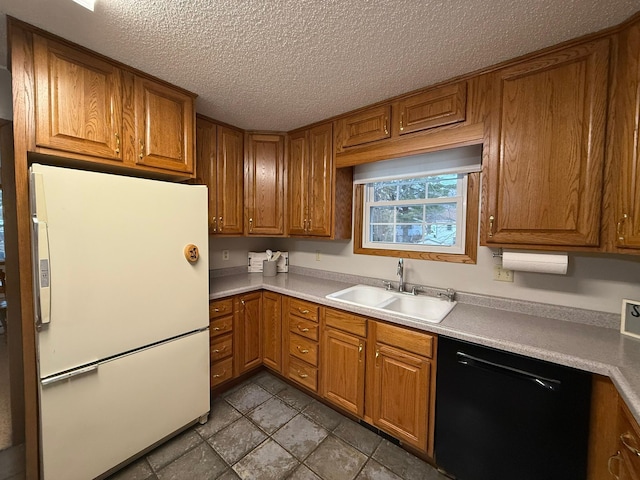 619 10th St, Montevideo, MN 56265 - kitchen featuring freestanding refrigerator, a sink, dishwasher, brown cabinets, and a textured ceiling