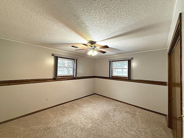 619 10th St, Montevideo, MN 56265 - unfurnished room featuring ceiling fan, carpet, a textured ceiling, baseboards, and crown molding