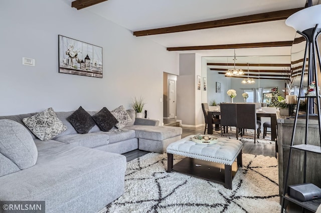 living room with lofted ceiling with beams, hardwood / wood-style flooring, and a chandelier