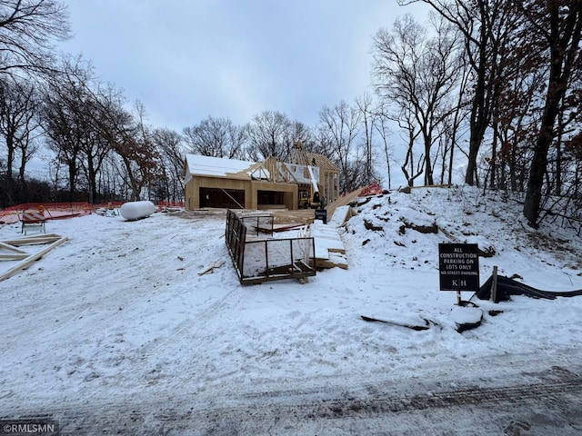 yard layered in snow featuring a garage