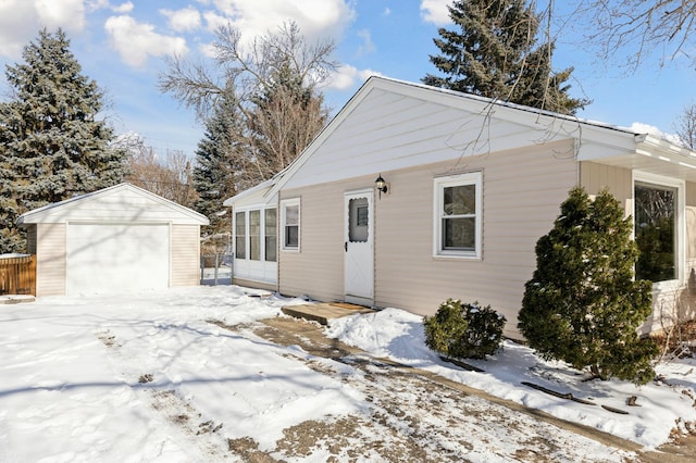 view of front of property with a garage and an outbuilding