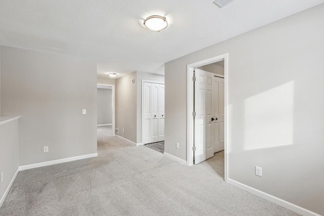 unfurnished room with light colored carpet