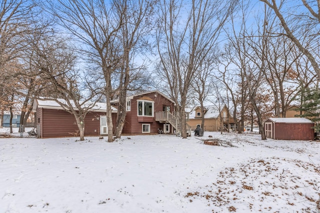 snow covered property with a storage unit