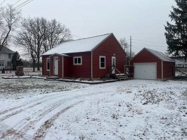 exterior space with an outbuilding and a garage