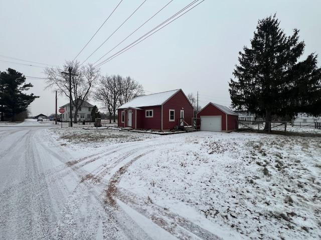 exterior space with a garage and an outbuilding