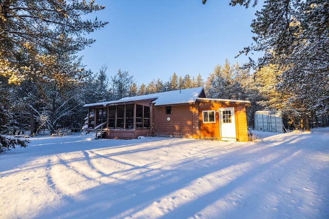 23790 360th St, Huntersville Twp, MN 56464 - snow covered house featuring a sunroom