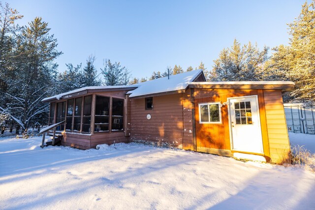23790 360th St, Huntersville Twp, MN 56464 - snow covered back of property with a sunroom