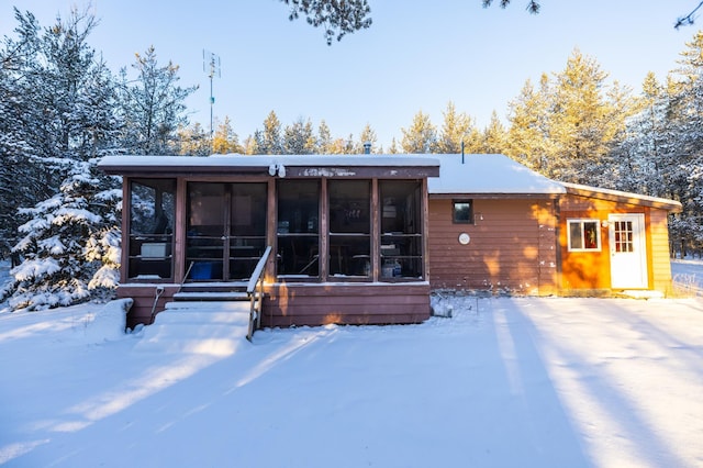 23790 360th St, Huntersville Twp, MN 56464 - snow covered house featuring a sunroom